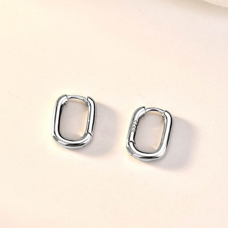 Detailed view of 14mm by 11mm hollow rectangle .925 sterling silver hoop earrings showing lightweight design and polished finish