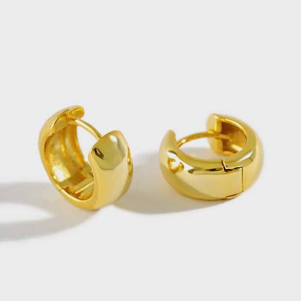 Detailed view of 10mm by 6.4mm mini circle sterling silver huggie hoop earrings showing polished finish.