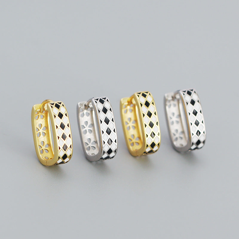 Detailed view of 15.2mm by 4.3mm chess board .925 sterling silver huggie hoop earrings showing engraved pattern and polished finish