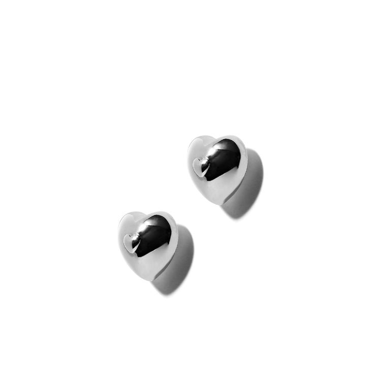 Detailed view of heart .925 sterling silver stud earrings showing delicate shape and polished finish