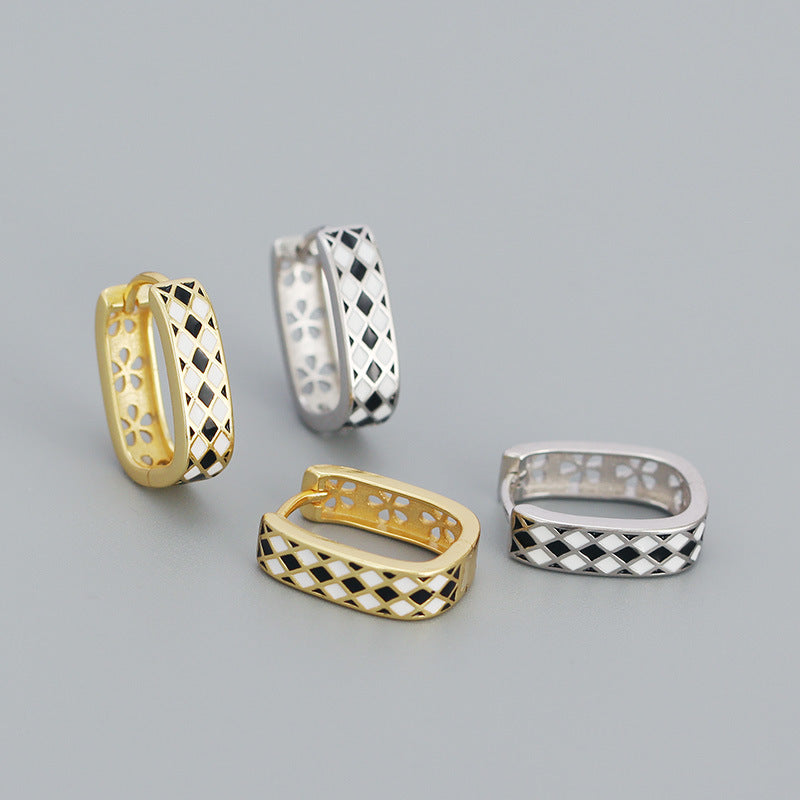 Detailed view of 15.2mm by 4.3mm chess board .925 sterling silver huggie hoop earrings showing engraved pattern and polished finish