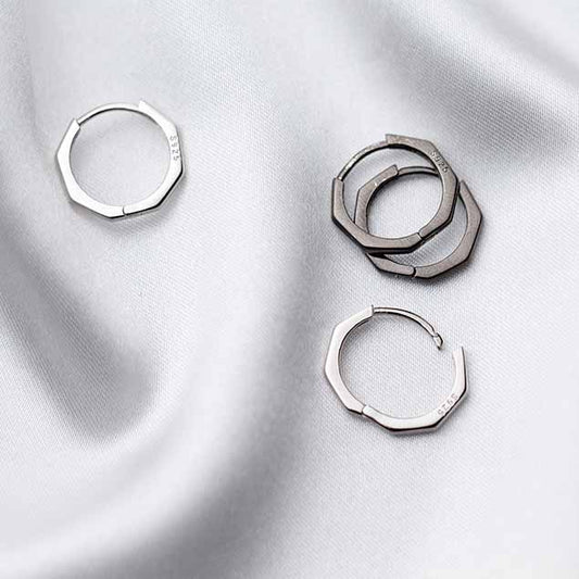 Detailed view of 13mm octagon .925 sterling silver hoop earrings showing geometric shape and polished finish