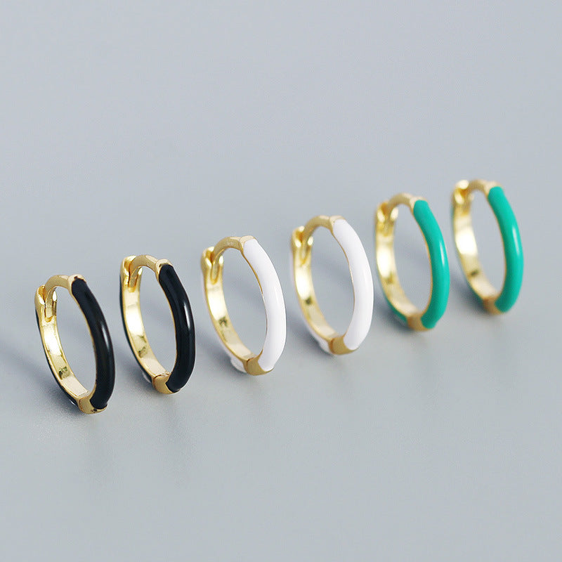 Detailed view of 12.6mm epoxy circle .925 sterling silver huggie hoop earrings showing smooth resin finish and polished silver