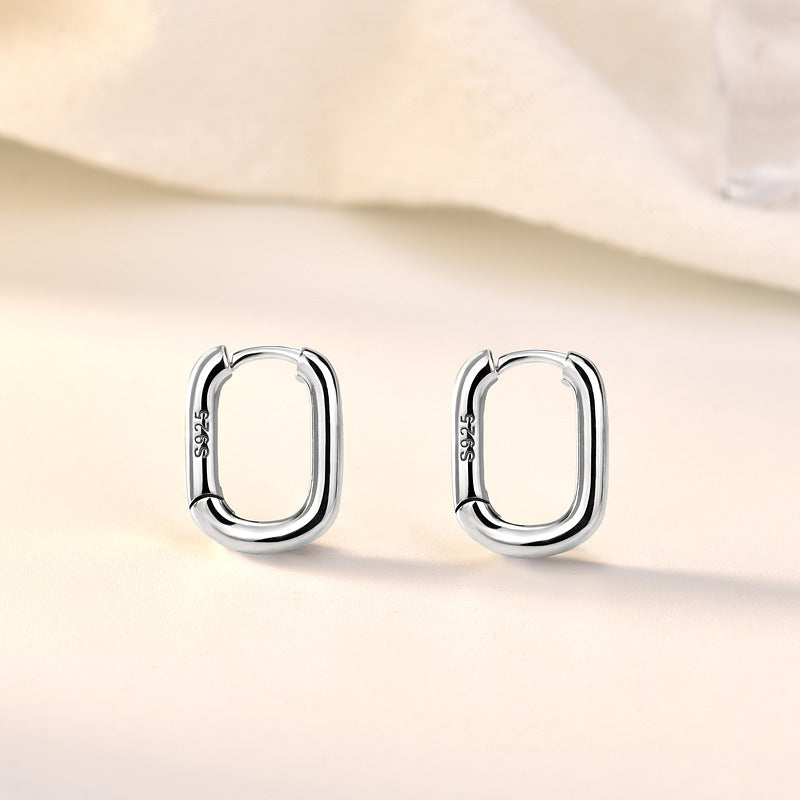 Detailed view of 14mm by 11mm hollow rectangle .925 sterling silver hoop earrings showing lightweight design and polished finish