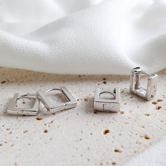 Detailed view of 5mm by 6mm and 6mm by 8mm hollow square .925 sterling silver hoop earrings showing lightweight design and polished finish