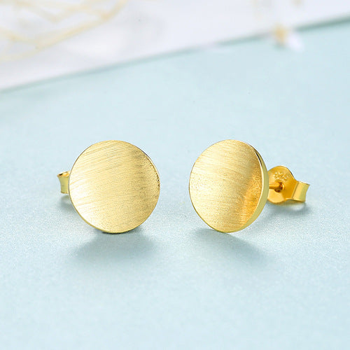 Detailed view of 9mm round .925 sterling silver stud earrings showing classic shape and polished finish