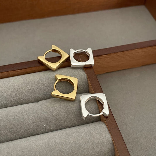 Detailed view of square .925 sterling silver hoop earrings showing modern shape and polished finish