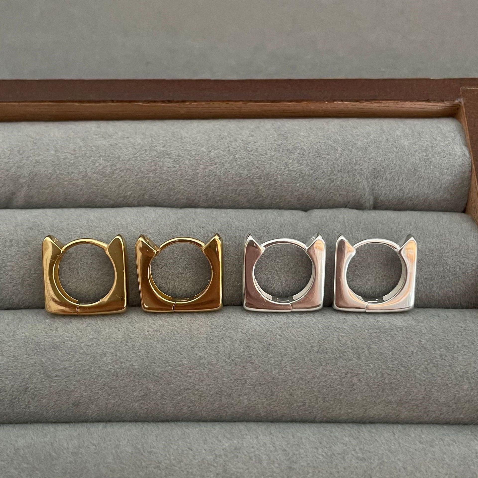 Detailed view of square .925 sterling silver hoop earrings showing modern shape and polished finish