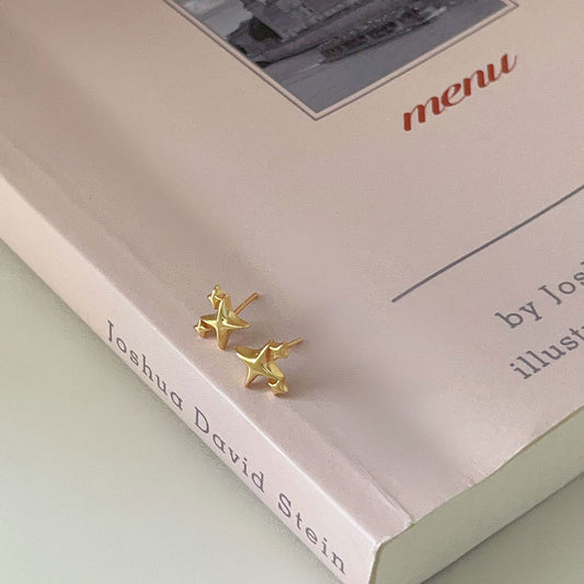 Detailed view of four pointed star .925 sterling silver stud earrings showing sharp geometric design and polished finish