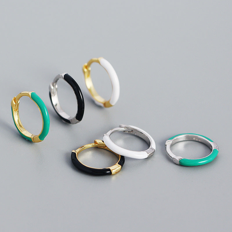 Detailed view of 12.6mm epoxy circle .925 sterling silver huggie hoop earrings showing smooth resin finish and polished silver
