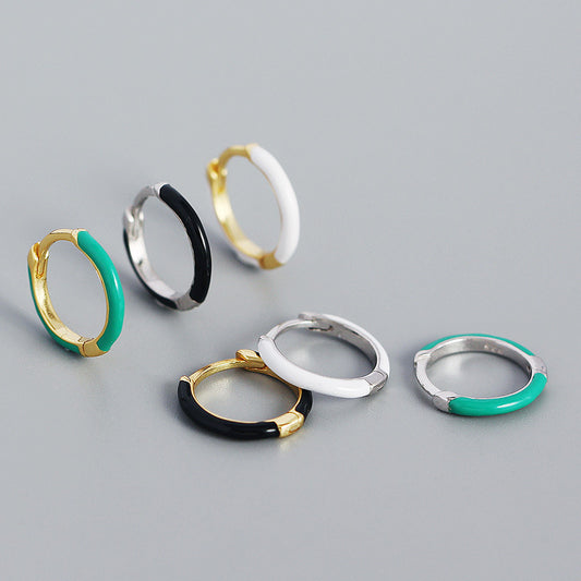 Detailed view of 12.6mm epoxy circle .925 sterling silver huggie hoop earrings showing smooth resin finish and polished silver