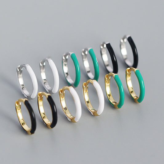 Detailed view of 12.6mm epoxy circle .925 sterling silver huggie hoop earrings showing smooth resin finish and polished silver