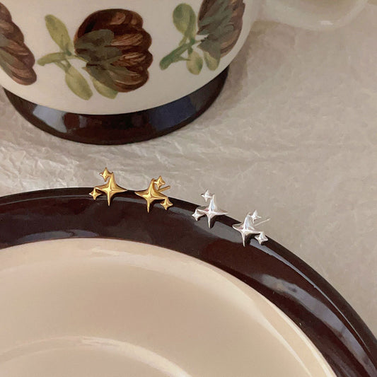 Detailed view of four pointed star .925 sterling silver stud earrings showing sharp geometric design and polished finish