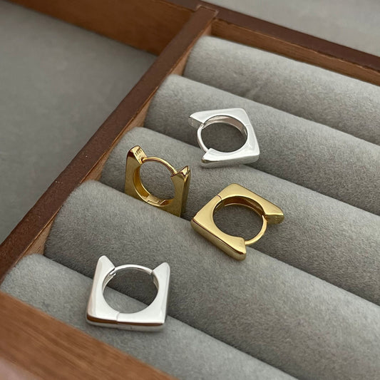 Detailed view of square .925 sterling silver hoop earrings showing modern shape and polished finish