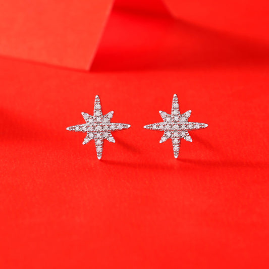 Detailed view of 10mm meteor star .925 sterling silver stud earrings showing textured design and polished finish
