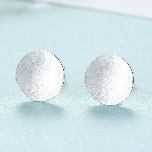 Detailed view of 9mm round .925 sterling silver stud earrings showing classic shape and polished finish