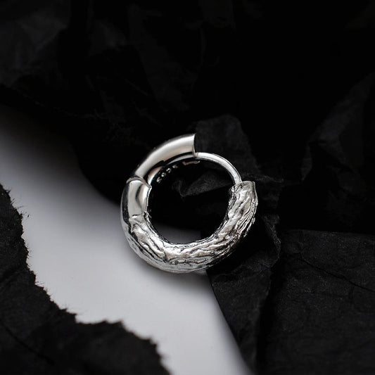 Detailed view of 10mm wrinkled .925 sterling silver hoop earrings showing textured surface and polished finish