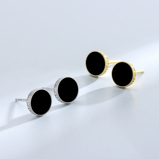 Detailed view of 7.8mm round .925 sterling silver black epoxy stud earrings showing smooth resin center and polished finish