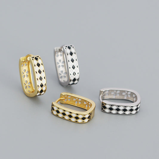Detailed view of 15.2mm by 4.3mm chess board .925 sterling silver huggie hoop earrings showing engraved pattern and polished finish