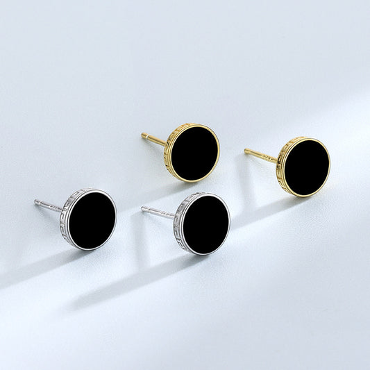 Detailed view of 7.8mm round .925 sterling silver black epoxy stud earrings showing smooth resin center and polished finish