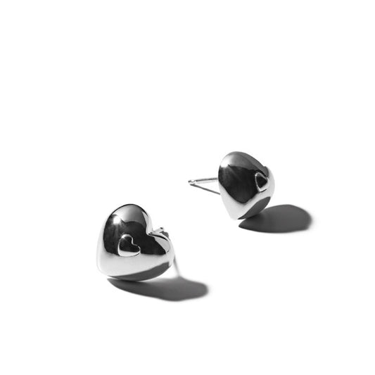 Detailed view of heart .925 sterling silver stud earrings showing delicate shape and polished finish